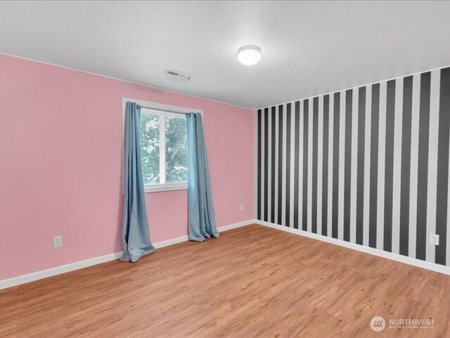 7335 33rd Ave NE, Lacey, WA 98516 - empty room featuring baseboards and light wood-type flooring
