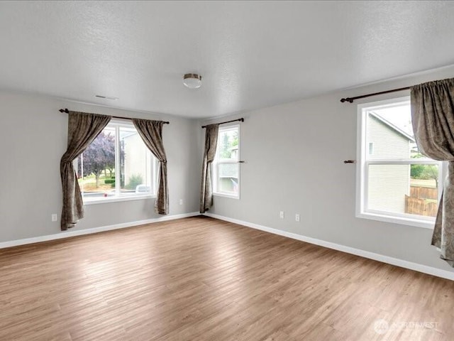 7335 33rd Ave NE, Lacey, WA 98516 - spare room featuring wood finished floors and a textured ceiling