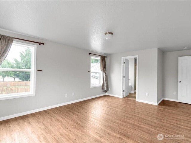 7335 33rd Ave NE, Lacey, WA 98516 - spare room with baseboards and light wood-style floors