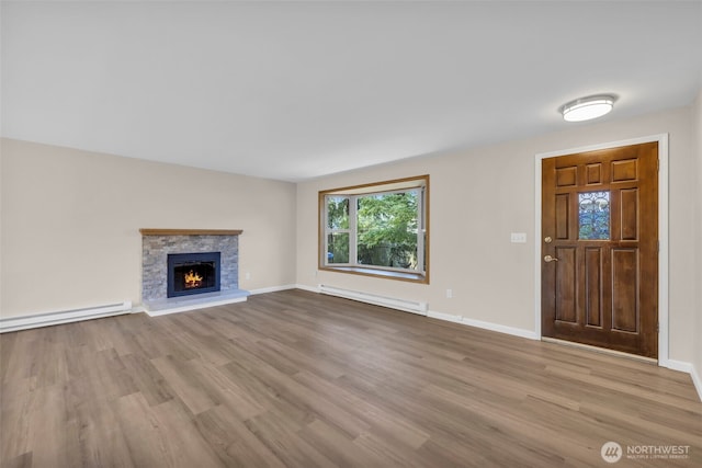 1229 SW 146th, Seahurst, WA 98168 - unfurnished living room with a baseboard radiator, wood finished floors, and a fireplace