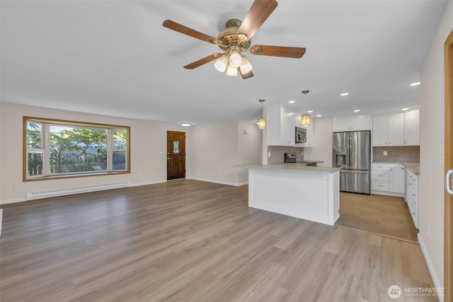 1229 SW 146th, Seahurst, WA 98168 - kitchen featuring appliances with stainless steel finishes, a baseboard heating unit, open floor plan, white cabinetry, and recessed lighting