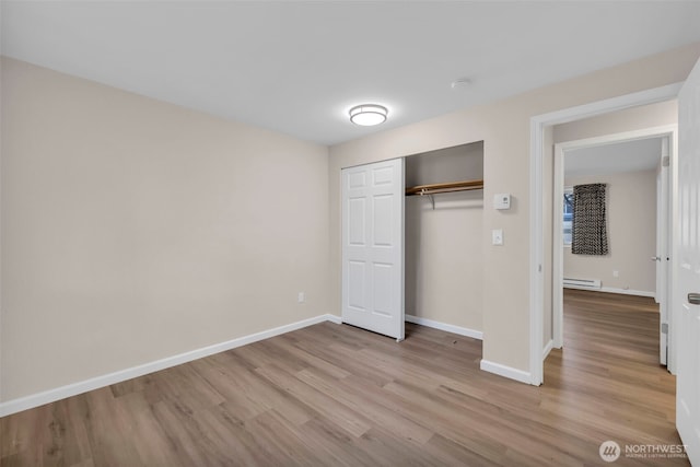 1229 SW 146th, Seahurst, WA 98168 - unfurnished bedroom featuring wood finished floors, a closet, and a baseboard heating unit
