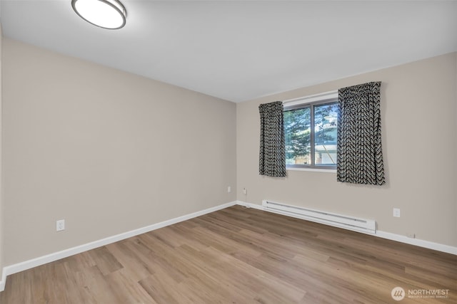1229 SW 146th, Seahurst, WA 98168 - empty room featuring baseboard heating and wood finished floors