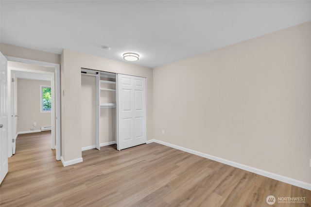 1229 SW 146th, Seahurst, WA 98168 - unfurnished bedroom featuring light wood finished floors, a closet, and baseboard heating
