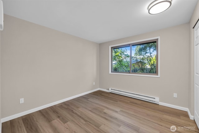 1229 SW 146th, Seahurst, WA 98168 - empty room with a baseboard radiator and wood finished floors