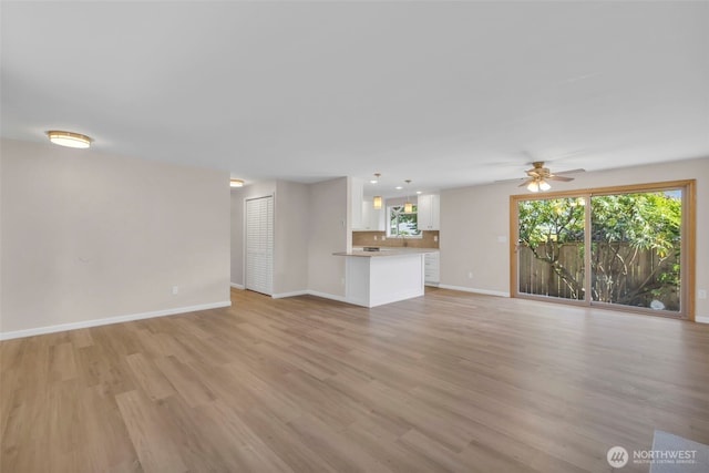 1229 SW 146th, Seahurst, WA 98168 - unfurnished living room featuring light wood-style flooring and a ceiling fan