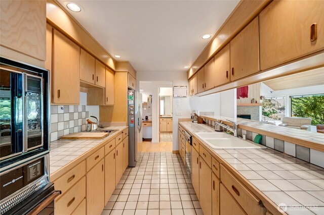 2314 140th Pl SE, Mill Creek, WA 98012 - kitchen featuring tile counters, freestanding refrigerator, tasteful backsplash, recessed lighting, and a brick fireplace