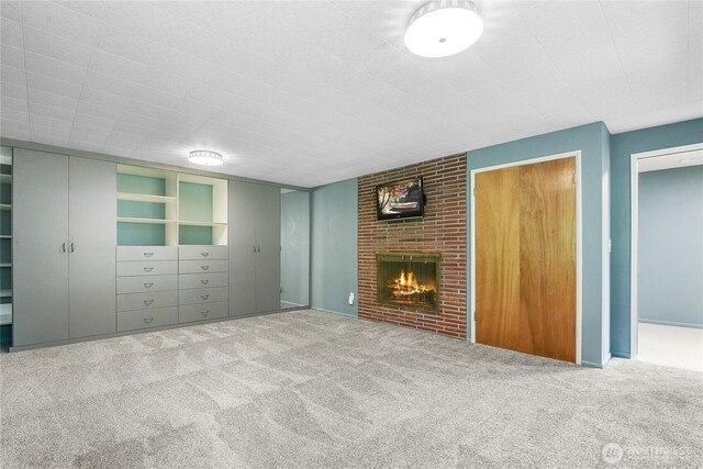 4211 Leavelle St NW, Olympia, WA 98502 - unfurnished living room featuring carpet and a brick fireplace