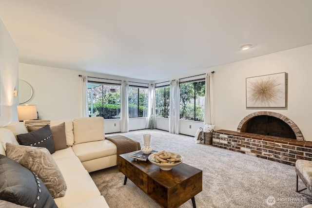 3434 25th Ave W Unit 101, Seattle, WA 98199 - living room with light colored carpet, healthy amount of natural light, and a fireplace