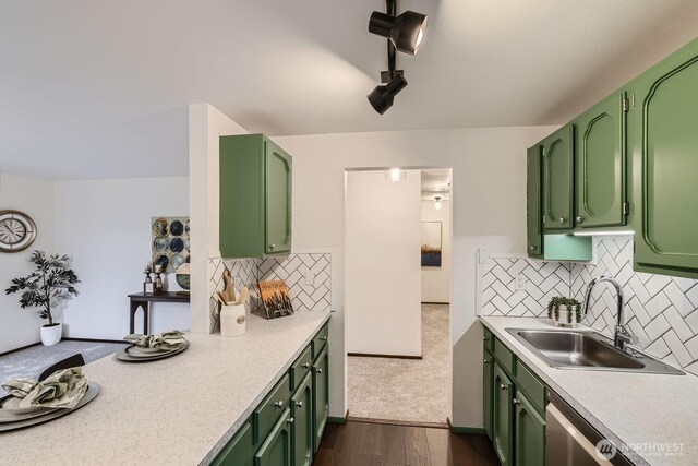 3434 25th Ave W Unit 101, Seattle, WA 98199 - kitchen with green cabinets, light countertops, dark wood-type flooring, and backsplash