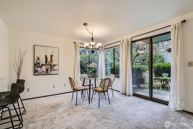 3434 25th Ave W Unit 101, Seattle, WA 98199 - carpeted dining room with a chandelier and baseboards