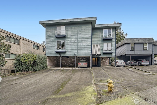 3434 25th Ave W Unit 101, Seattle, WA 98199 - back of house featuring covered and uncovered parking