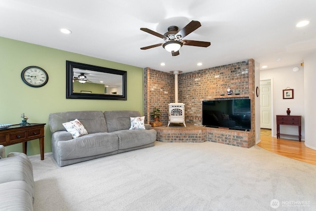30308 104th Ave, Auburn, WA 98092 - living area featuring a wood stove, carpet floors, recessed lighting, and ceiling fan