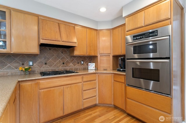 30308 104th Ave, Auburn, WA 98092 - kitchen with double oven, gas cooktop, light wood-style floors, tasteful backsplash, and glass insert cabinets
