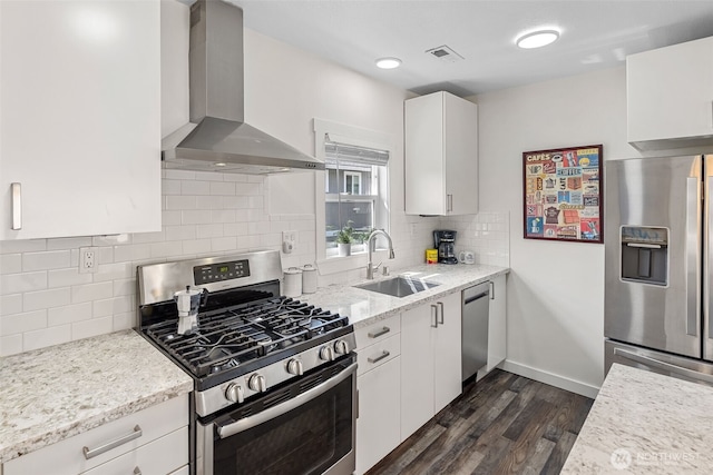 1040 S Director St Unit A, Seattle, WA 98108 - kitchen featuring stainless steel appliances, wall chimney exhaust hood, dark wood-style floors, and white cabinetry
