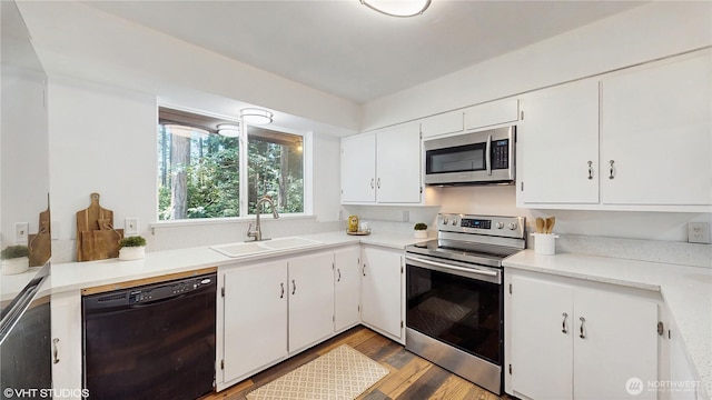 5169 Banner Rd SE, Port Orchard, WA 98367 - kitchen featuring stainless steel appliances, wood finished floors, white cabinets, and light countertops