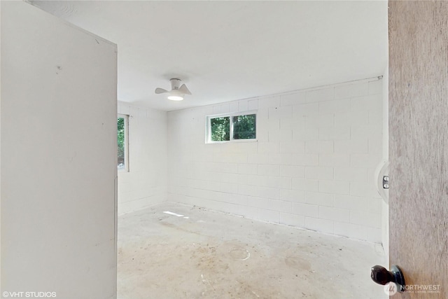 5169 Banner Rd SE, Port Orchard, WA 98367 - spare room with concrete block wall and concrete flooring