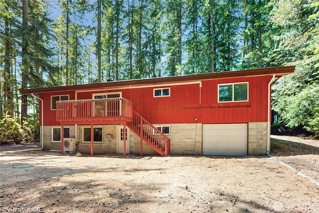 5169 Banner Rd SE, Port Orchard, WA 98367 - rustic home with driveway, stairs, a deck, and an attached garage