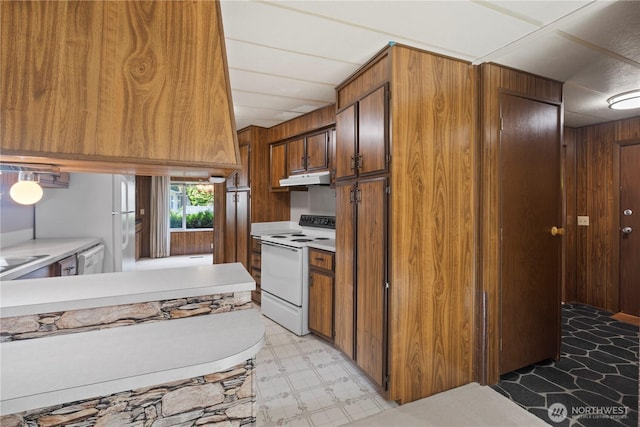 4915 Samish Unit 66, Bellingham, WA 98229 - kitchen featuring electric stove, under cabinet range hood, brown cabinetry, light countertops, and light floors