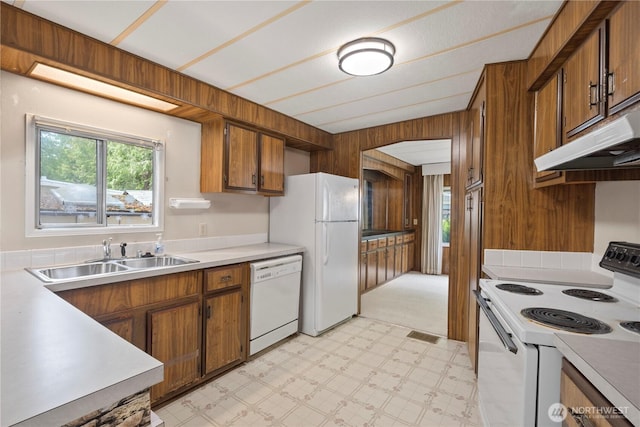 4915 Samish Unit 66, Bellingham, WA 98229 - kitchen featuring white appliances, wooden walls, brown cabinetry, healthy amount of natural light, and light floors
