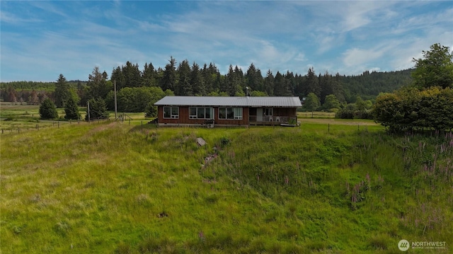 752 Parpala, Naselle, WA 98638 - view of front of house with a view of trees, a metal roof, and a rural view