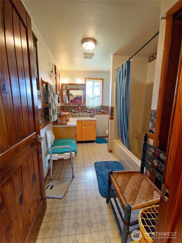 752 Parpala, Naselle, WA 98638 - bathroom with tile patterned floors, vanity, a textured ceiling, and shower / bath combination with curtain
