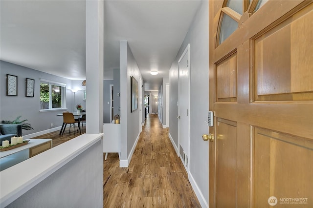 21628 SE 271st St, Maple Valley, WA 98038 - hallway with light wood-type flooring and baseboards
