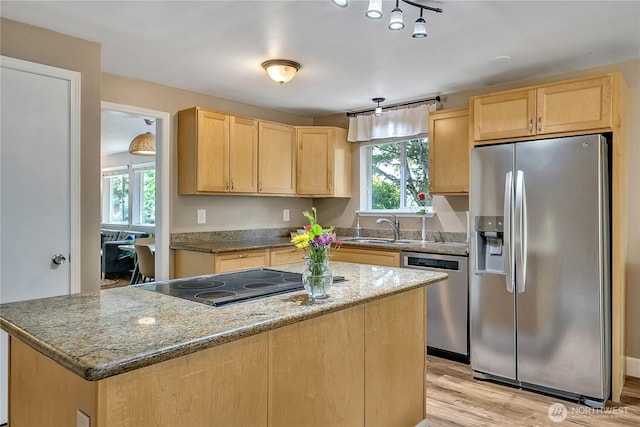 21628 SE 271st St, Maple Valley, WA 98038 - kitchen with appliances with stainless steel finishes, light brown cabinetry, plenty of natural light, and light wood-style floors