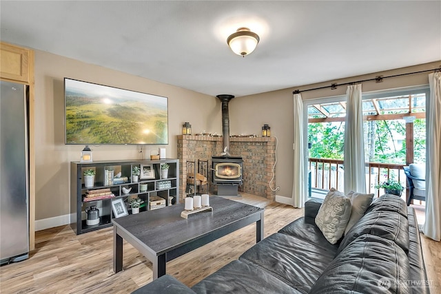 21628 SE 271st St, Maple Valley, WA 98038 - living area featuring a wood stove and light wood finished floors