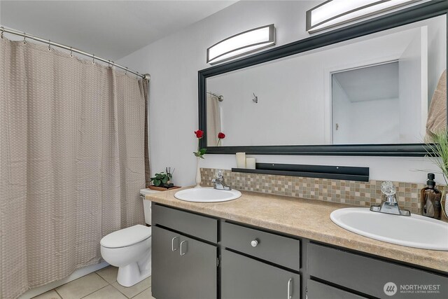 21628 SE 271st St, Maple Valley, WA 98038 - full bathroom with double vanity, tile patterned flooring, decorative backsplash, and a shower with shower curtain