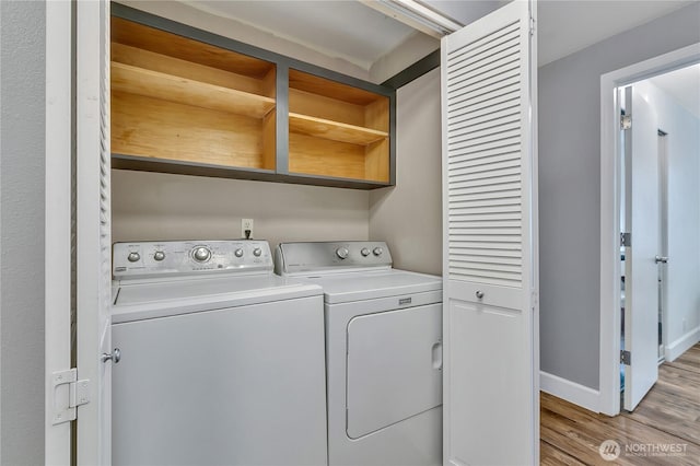 21628 SE 271st St, Maple Valley, WA 98038 - laundry area featuring independent washer and dryer and light wood-style floors