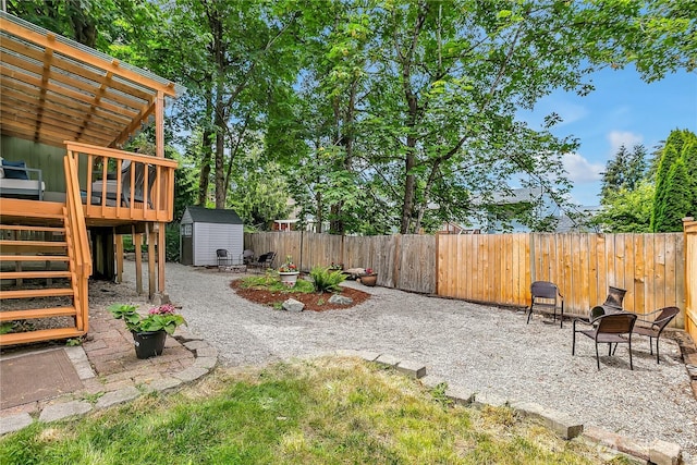 21628 SE 271st St, Maple Valley, WA 98038 - fenced backyard with a storage unit, a deck, and stairs