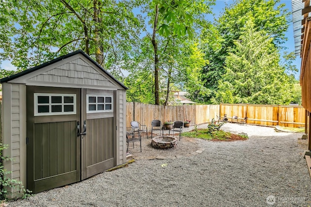 21628 SE 271st St, Maple Valley, WA 98038 - view of shed with an outdoor fire pit and a fenced backyard