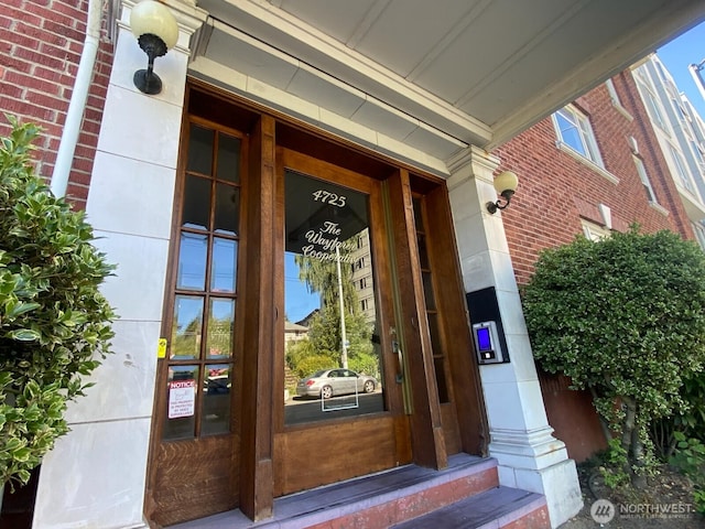 4725 15th Ave NE Unit 14, Seattle, WA 98105 - view of exterior entry featuring covered porch and brick siding