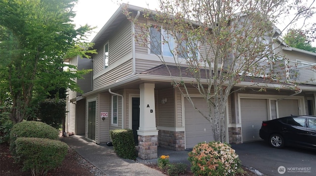 6121 Hazel Ave SE Unit A4, Auburn, WA 98092 - view of front of house with a garage, stone siding, and driveway
