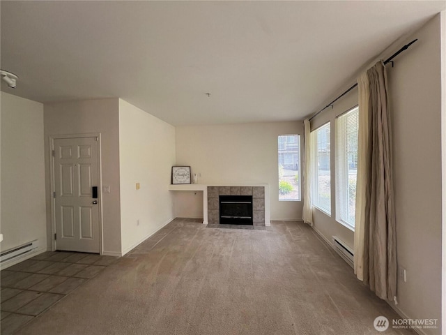 6121 Hazel Ave SE Unit A4, Auburn, WA 98092 - unfurnished living room featuring a baseboard heating unit, carpet floors, and a tile fireplace