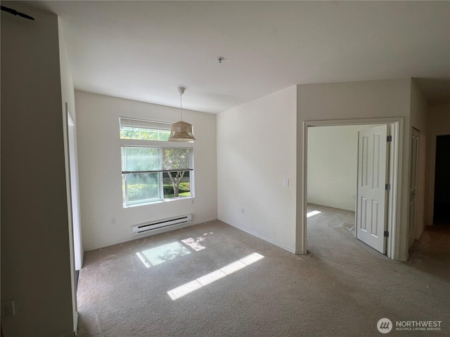 6121 Hazel Ave SE Unit A4, Auburn, WA 98092 - spare room featuring a baseboard radiator, light carpet, and fire sprinkler in ceiling