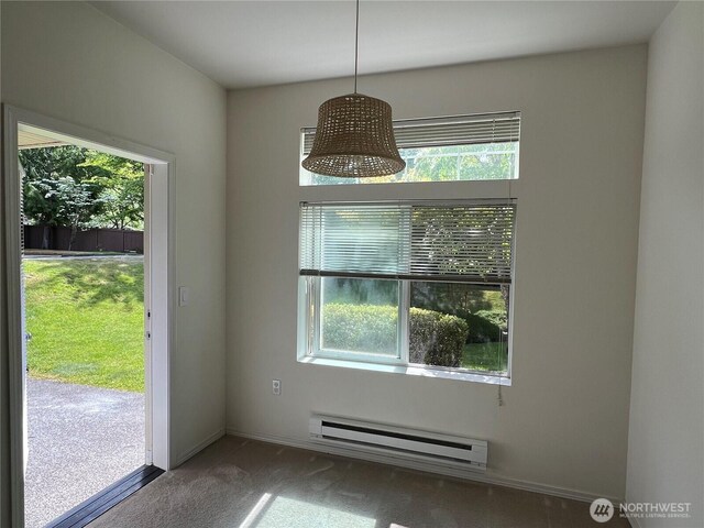 6121 Hazel Ave SE Unit A4, Auburn, WA 98092 - unfurnished dining area with baseboard heating, plenty of natural light, and carpet flooring