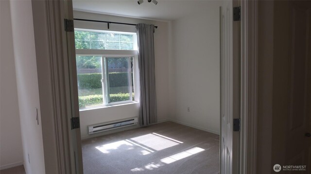 6121 Hazel Ave SE Unit A4, Auburn, WA 98092 - carpeted spare room with a baseboard heating unit and baseboards