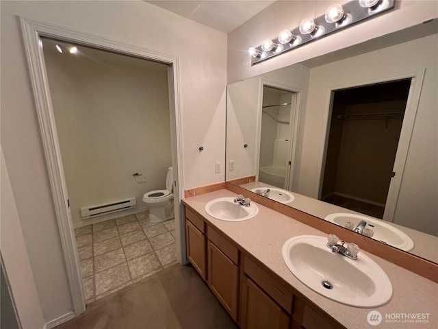 6121 Hazel Ave SE Unit A4, Auburn, WA 98092 - full bathroom featuring baseboard heating, double vanity, a walk in closet, and a shower