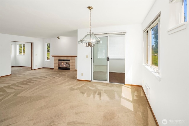1312 S Massachusetts St Unit 202, Seattle, WA 98144 - unfurnished living room featuring light carpet, a chandelier, and a fireplace