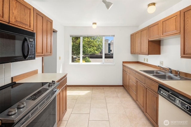 1312 S Massachusetts St Unit 202, Seattle, WA 98144 - kitchen featuring white dishwasher, black microwave, stainless steel electric range oven, brown cabinetry, and light countertops