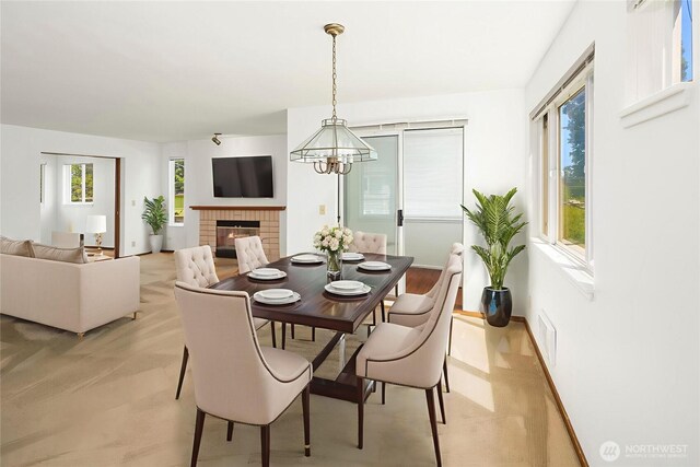 1312 S Massachusetts St Unit 202, Seattle, WA 98144 - dining area featuring a chandelier and a brick fireplace