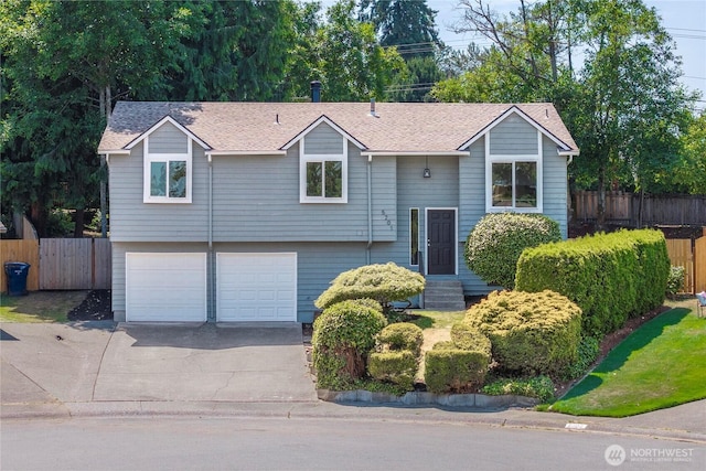 5201 S 298th Ct, Auburn, WA 98001 - split foyer home with concrete driveway, a garage, and roof with shingles