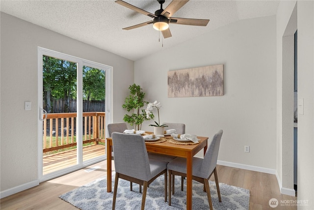 5201 S 298th Ct, Auburn, WA 98001 - dining room with a ceiling fan, wood finished floors, vaulted ceiling, and a textured ceiling