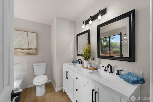 5201 S 298th Ct, Auburn, WA 98001 - bathroom featuring double vanity, wood finished floors, and a tub to relax in