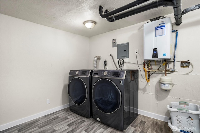 2855 SW 300th Pl, Federal Way, WA 98023 - laundry area featuring electric panel, water heater, washing machine and dryer, wood finished floors, and a textured ceiling