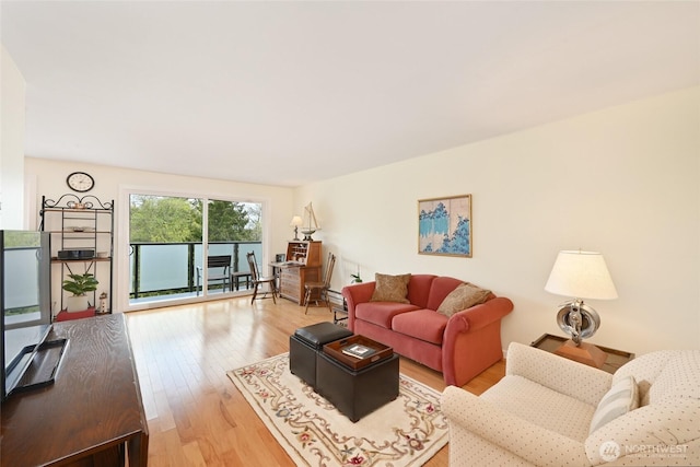 3722 27th Pl W Unit 301, Seattle, WA 98199 - living area with wood finished floors and a baseboard heating unit