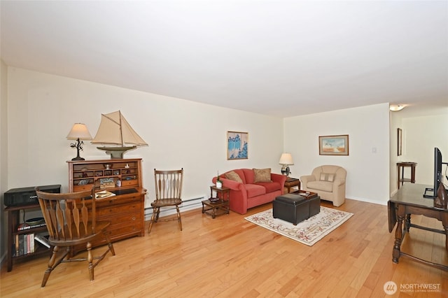 3722 27th Pl W Unit 301, Seattle, WA 98199 - living area with baseboard heating and light wood-style floors