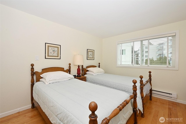 3722 27th Pl W Unit 301, Seattle, WA 98199 - bedroom with baseboard heating and light wood-style flooring